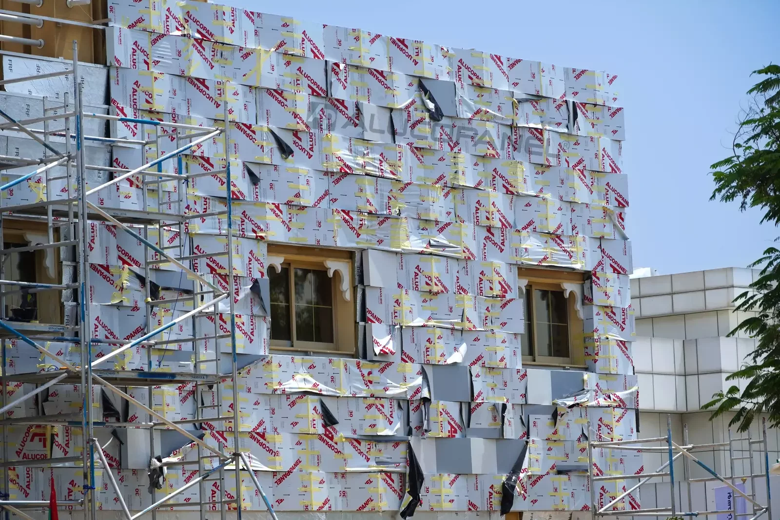 Novamed facade with scaffolding during ALUCOPANEL cladding works