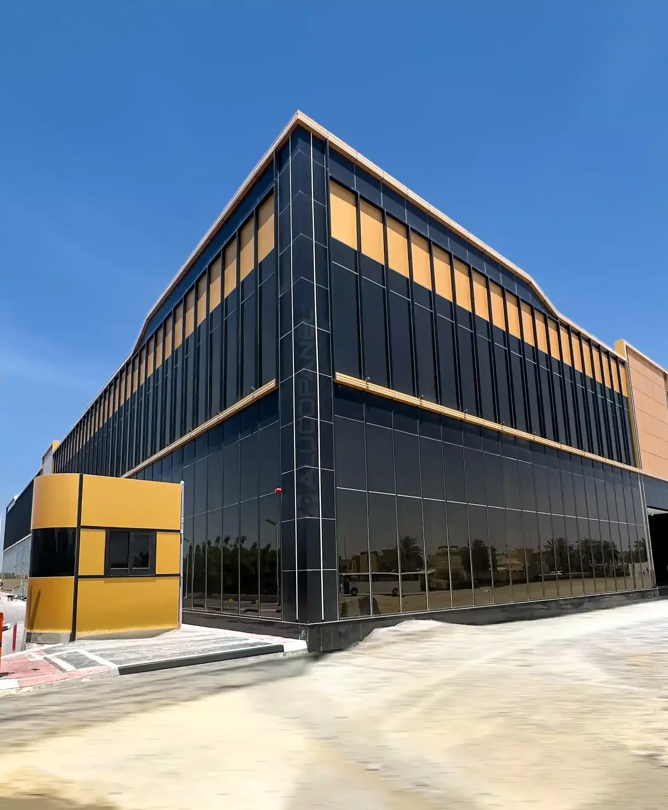 Corner of Moopans Mall with gold and black ALUCOPANEL cladding and reflective glass