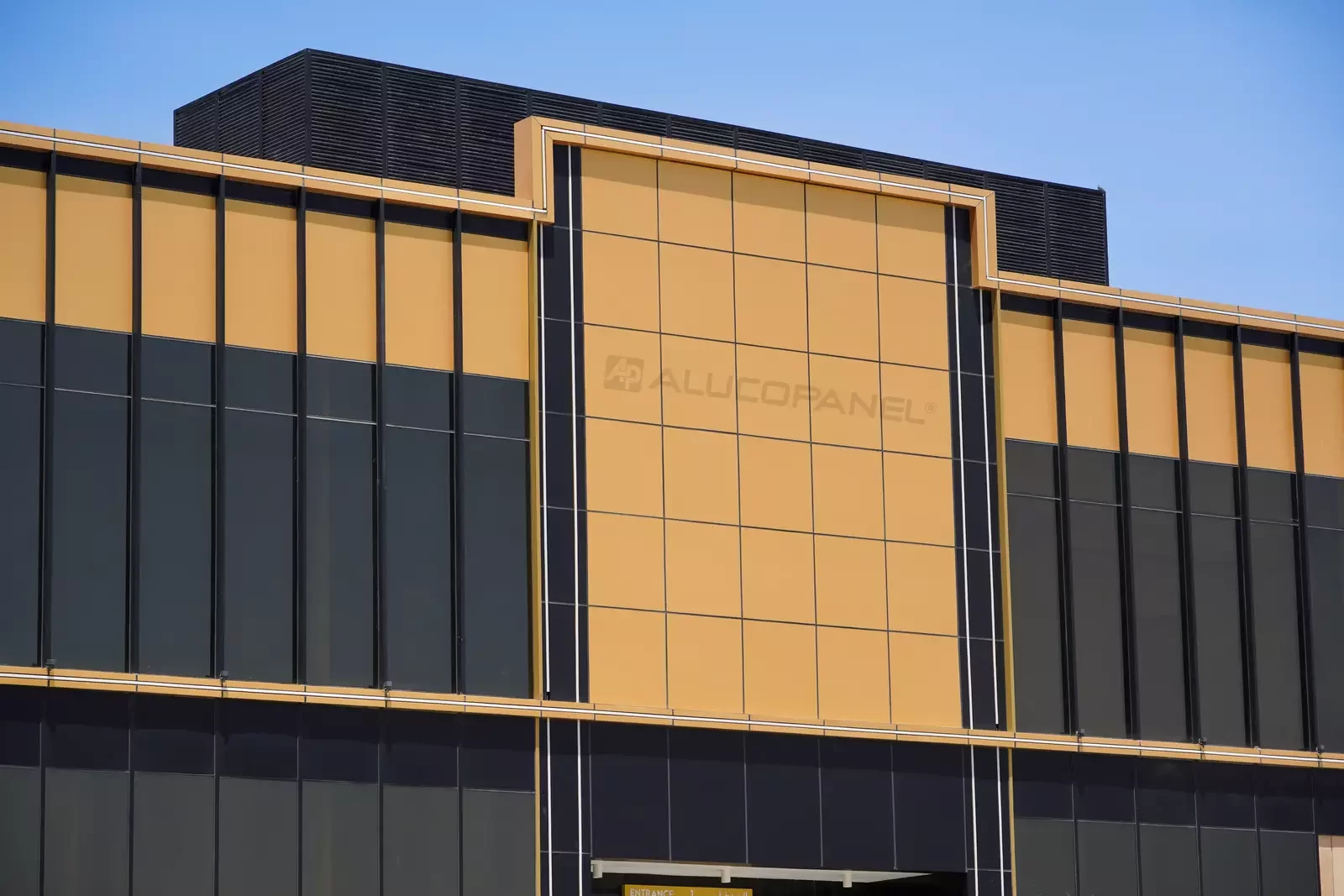 Gold ALUCOPANEL cladding on the entrance canopy, Moopans Mall