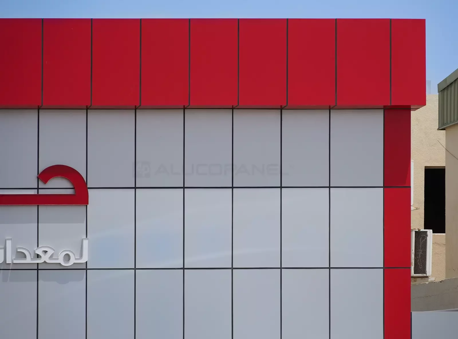 Red and silver ALUCOPANEL parapet detail on the Habshan building