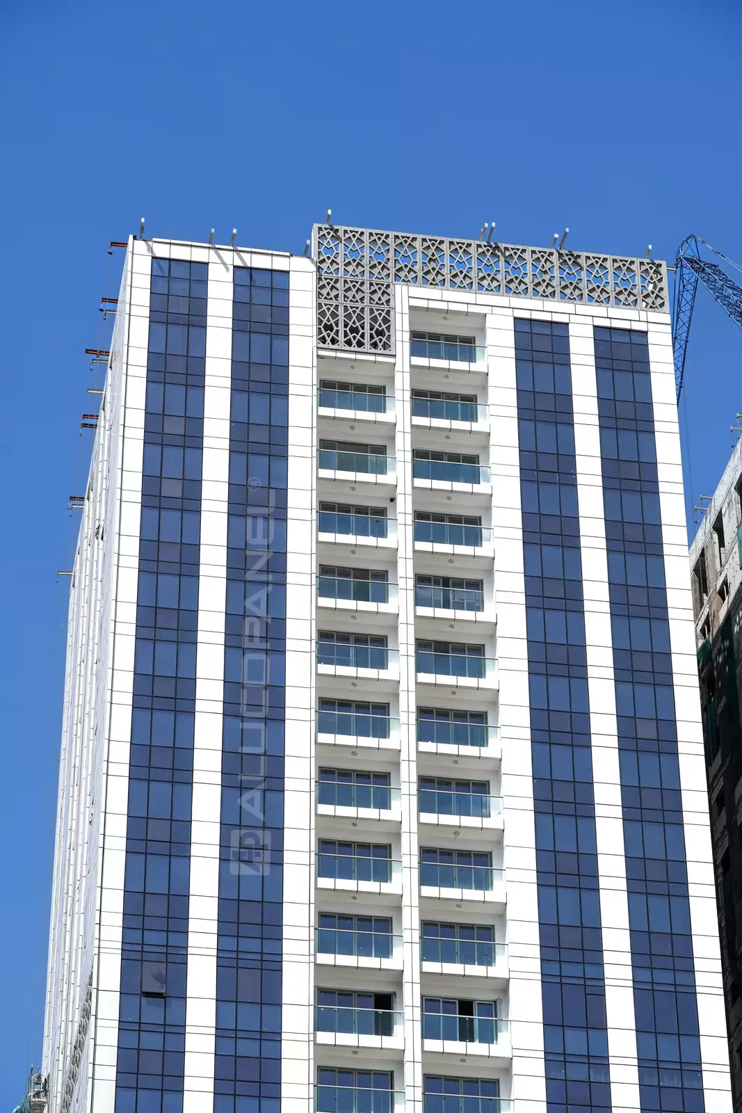 Full view of the white ALUCOPANEL clad Ajman Res Tower