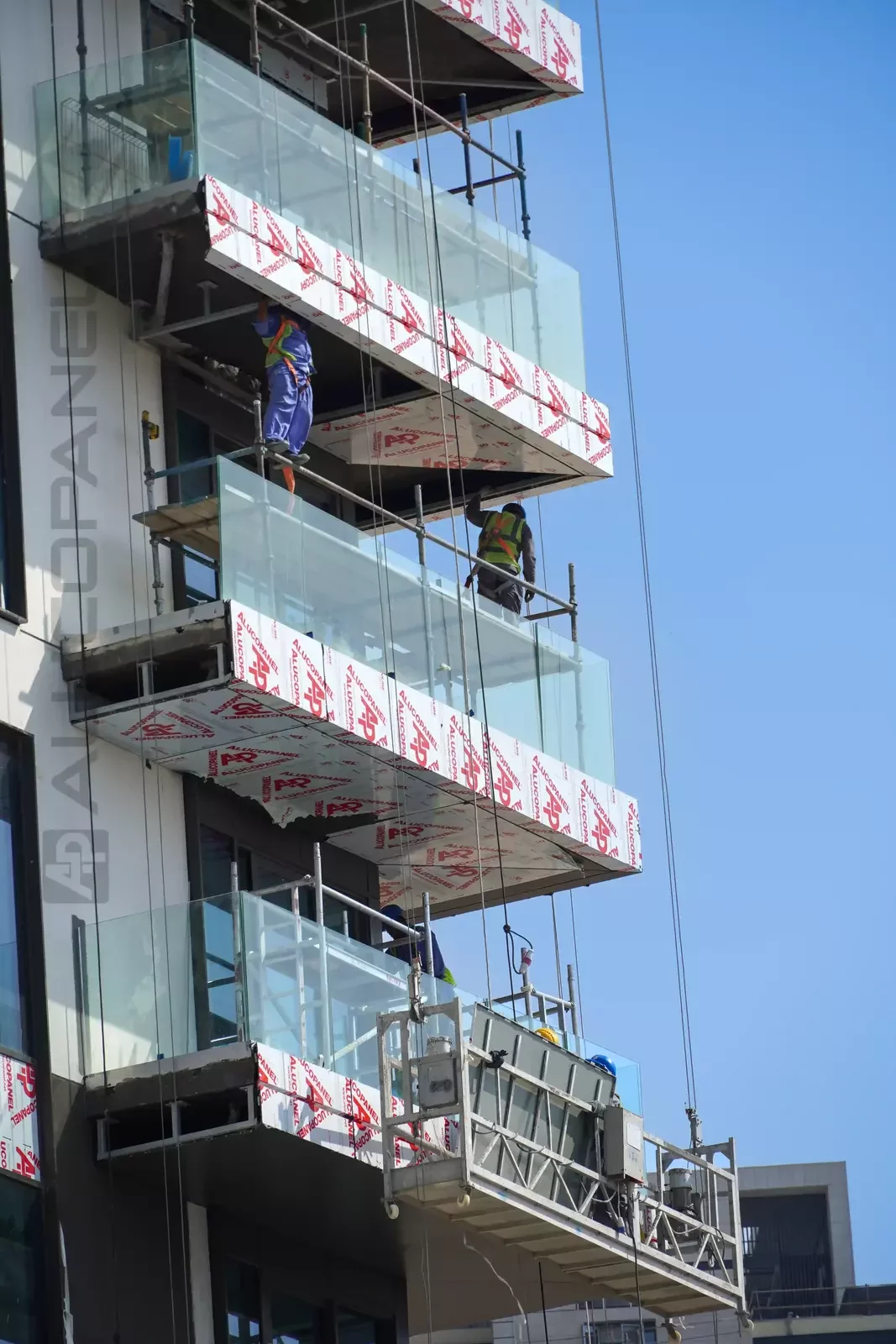 Installers fitting ALUCOPANEL on a balcony at Green Side Residences